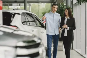Car dealership discussion between man and woman.