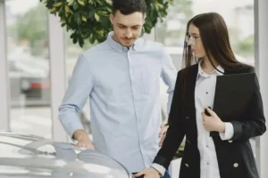 Man and woman discussing car purchase.
