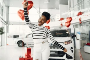 A happy women with key in hand.